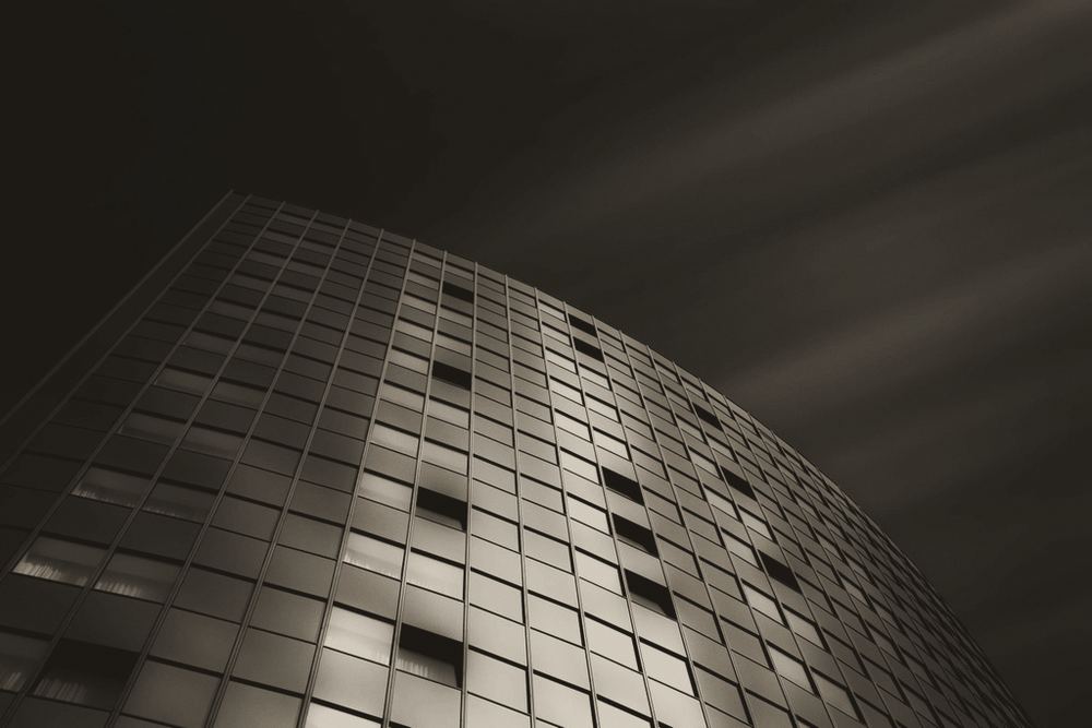 An office tower of glass and steel against the sky